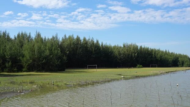 View of a football field by the water in Bangladesh.