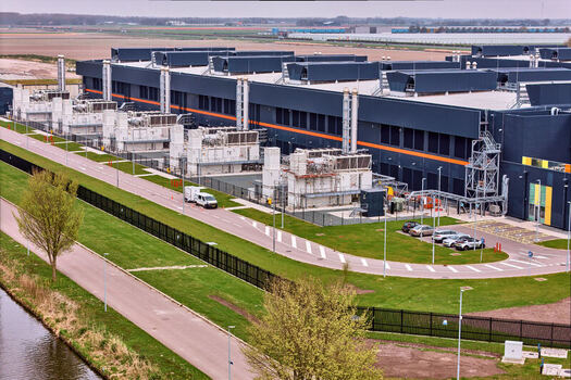 Middenmeer Netherlands 15 April 2026 Aerial view of Microsoft Datacenter Campus AMS 13 and 14 showing industrial cooling units parking areas and access roads under a hazy sky. Middenmeer Netherlands 15 April 2026 Aerial view of Microsoft Datacenter Campus AMS 13 and 14 showing industrial cooling units parking areas and access roads under a hazy sky.