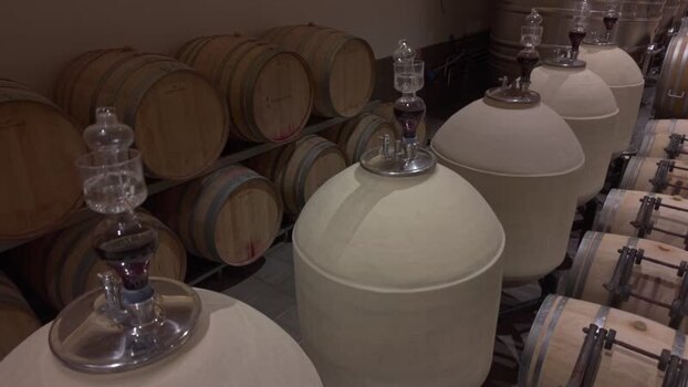 View of wine barrels and tanks in cellar of Couhins Lurton castle France.