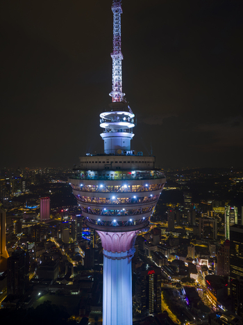 Kuala Lumpur Malaysia 11 March 2026 Aerial view of the illuminated Kuala Lumpur Tower at night with the glowing city skyline and urban lights in the background.