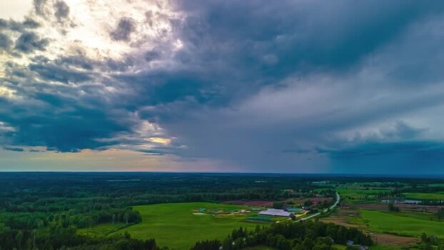 Aerial view of rural landscape under stormy sky in Latvia. Aerial view of rural landscape under stormy sky in Latvia.
