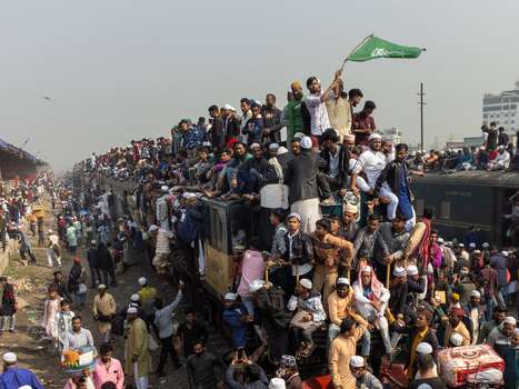 Tongi Bangladesh 04 February 2024 Aerial view of Tongi Junction railway station crowded with people sitting on the roof and hanging from a train during the Biswa Ijtema festival. Tongi Bangladesh 04 February 2024 Aerial view of Tongi Junction railway station crowded with people sitting on the roof and hanging from a train during the Biswa Ijtema festival.