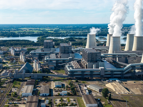 Aerial view of the Janschwalde Power Station with its prominent cooling towers emitting steam plumes surrounded by industrial infrastructure in Peitz Brandenburg Germany. Aerial view of the Janschwalde Power Station with its prominent cooling towers emitting steam plumes surrounded by industrial infrastructure in Peitz Brandenburg Germany.