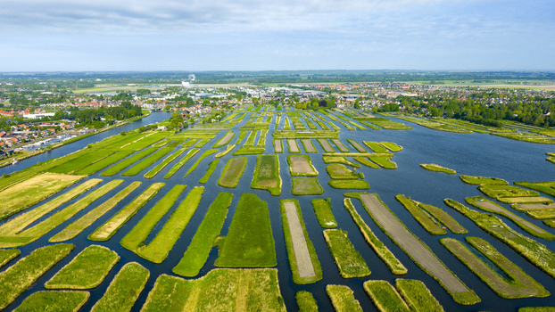 Aerial view of the Oosterdel nature reserve with its unique network of small green islands and water channels in Broek op Langedijk Noord Holland Netherlands. Aerial view of the Oosterdel nature reserve with its unique network of small green islands and water channels in Broek op Langedijk Noord Holland Netherlands.