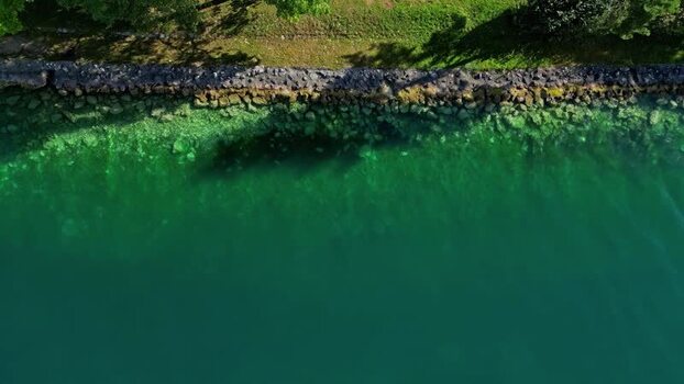 Aerial view of Attersee shoreline with clear turquoise water Austria.