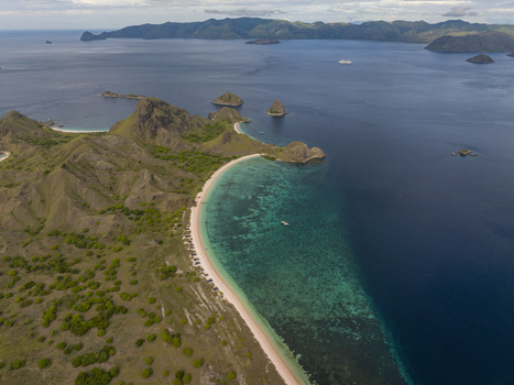 Aerial view of Pink Beach with its distinctive pink sand turquoise waters and surrounding hills in East Nusa Tenggara Indonesia. Aerial view of Pink Beach with its distinctive pink sand turquoise waters and surrounding hills in East Nusa Tenggara Indonesia.