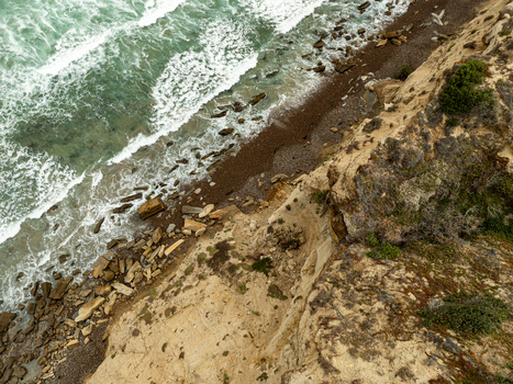 Aerial view of the steep sandstone cliffs and turquoise ocean waves at La Jolla Cove in San Diego California United States. Aerial view of the steep sandstone cliffs and turquoise ocean waves at La Jolla Cove in San Diego California United States.