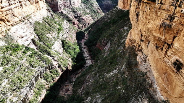 Aerial view of the deep El Vergel canyon with steep rock walls lush green vegetation and a river flowing through the bottom Torotoro Potosi Department Bolivia. Aerial view of the deep El Vergel canyon with steep rock walls lush green vegetation and a river flowing through the bottom Torotoro Potosi Department Bolivia.