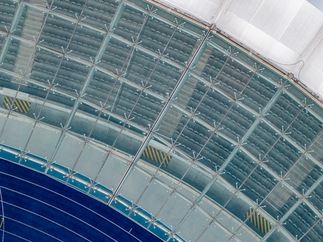 Berlin Germany 26 September 2026 Aerial view of Olympiastadion Berlin featuring its distinctive glass roof structure rows of stadium seating and a section of the blue running track.