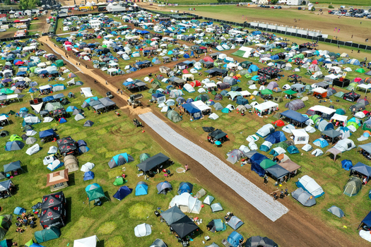 Herzogenaurach Germany 27 July 2025 Aerial view of the Open Beatz Festival campsite featuring numerous colorful tents and dirt paths on a sunny day. Herzogenaurach Germany 27 July 2025 Aerial view of the Open Beatz Festival campsite featuring numerous colorful tents and dirt paths on a sunny day.
