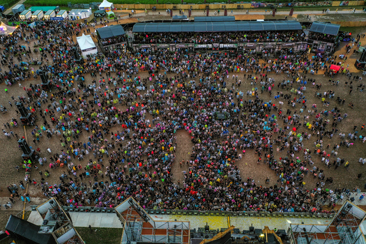 Herzogenaurach Germany 26 July 2025 Aerial view of Open Beatz Festival with a massive crowd of people gathered in front of stages and tents on a large field.