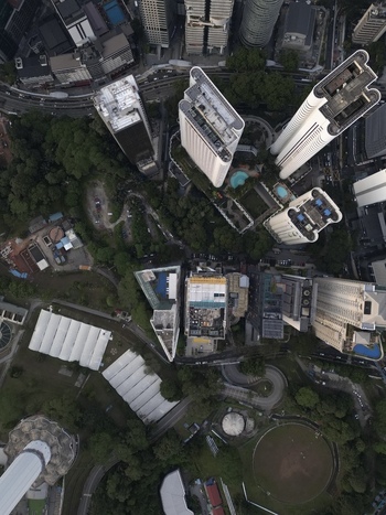 Aerial view of modern skyscrapers lush urban greenery and winding city streets in Kuala Lumpur Federal Territory of Malaysia. Aerial view of modern skyscrapers lush urban greenery and winding city streets in Kuala Lumpur Federal Territory of Malaysia.