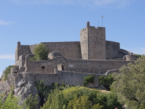 View of the historic stone fortifications of Marvao Castle set against a clear blue sky in Marvao Portalegre District Portugal. View of the historic stone fortifications of Marvao Castle set against a clear blue sky in Marvao Portalegre District Portugal.