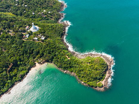 Aerial view of the Japanese Peace Pagoda and Jungle Beach surrounded by lush tropical forest and turquoise ocean in Unawatuna Sri Lanka. Aerial view of the Japanese Peace Pagoda and Jungle Beach surrounded by lush tropical forest and turquoise ocean in Unawatuna Sri Lanka.
