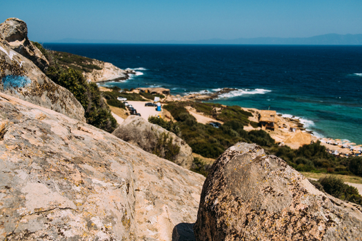 View of the rocky coastline and turquoise sea at Neos Marmaras Greece.
