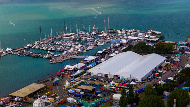 Aerial view of the Southampton Boat Show with yachts and sailboats docked in the marina large white event marquees and walkways along the waterfront in Southampton England United Kingdom. Aerial view of the Southampton Boat Show with yachts and sailboats docked in the marina large white event marquees and walkways along the waterfront in Southampton England United Kingdom.