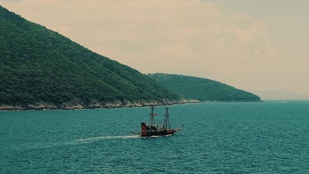 Aerial view of a wooden pirate ship sailing along the coast Albania. Aerial view of a wooden pirate ship sailing along the coast Albania.