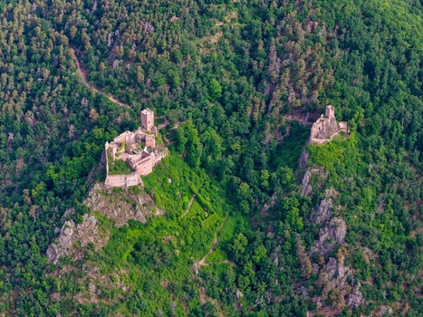 Aerial view of the medieval castle ruins of Saint Ulrich and Girsberg on rocky forested hilltops overlooking Ribeauville Grand Est France. Aerial view of the medieval castle ruins of Saint Ulrich and Girsberg on rocky forested hilltops overlooking Ribeauville Grand Est France.