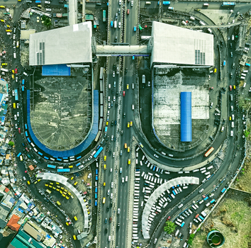 Aerial view of the bustling cityscape where the elevated train station meets the chaotic colourful roads below Bangkok Thailand. Aerial view of the bustling cityscape where the elevated train station meets the chaotic colourful roads below Bangkok Thailand.