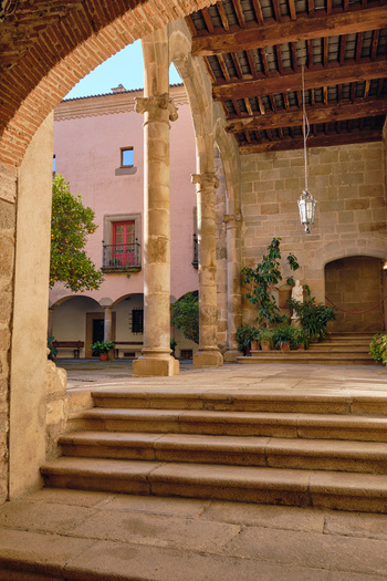 Plasencia Spain 03 December 2025 View of the historic courtyard of the Catedral Nueva de Plasencia with stone columns arches and steps under a wooden ceiling. Plasencia Spain 03 December 2025 View of the historic courtyard of the Catedral Nueva de Plasencia with stone columns arches and steps under a wooden ceiling.