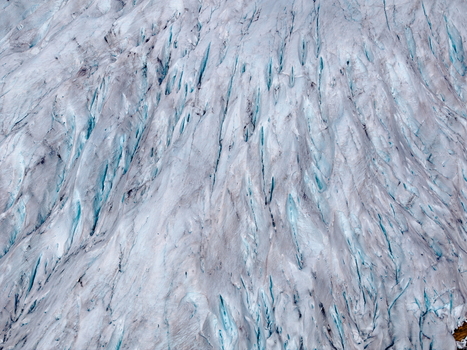 Aerial view of the icy crevasses and deep blue fissures of the Svartisen glacier in Saltfjellet Svartisen National Park Rana Municipality Nordland Norway.