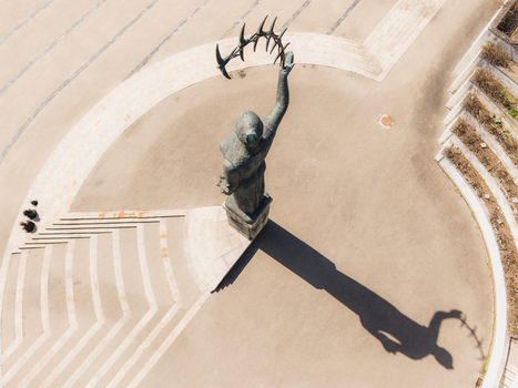 Aerial view of the statue in Chiune Sugihara Sakura Park casting a long shadow on the paved ground in Vilnius Vilniaus apskritis Lithuania. Aerial view of the statue in Chiune Sugihara Sakura Park casting a long shadow on the paved ground in Vilnius Vilniaus apskritis Lithuania.