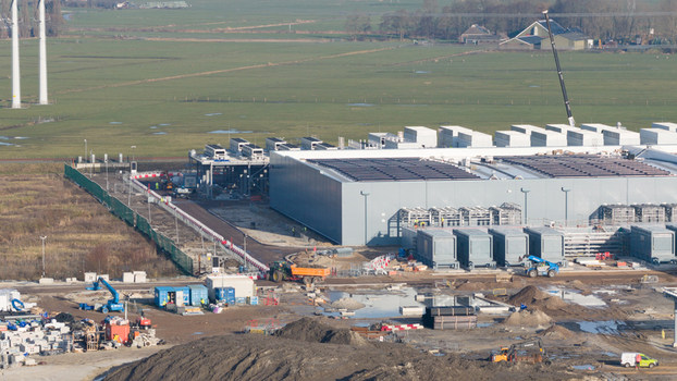 Groningen Netherlands 20 January 2026 Aerial view of Datacenter Westpoort under construction with heavy machinery cooling systems and solar panels on the roof.