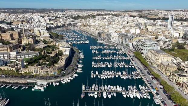 Aerial view of yachts docked in the marina with urban buildings Malta. Aerial view of yachts docked in the marina with urban buildings Malta.