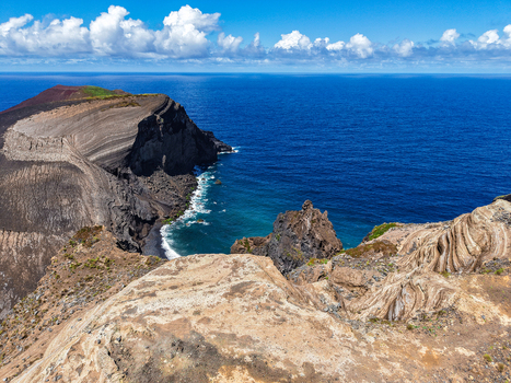 Aerial view of the stark volcanic landscape contrasting with the azure sea and the dramatic cliffs of Capelinhos Volcano Capelo A&ccedil;ores Portugal.