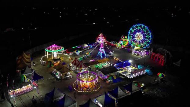 Aerial view of illuminated carnival rides at night Indonesia.