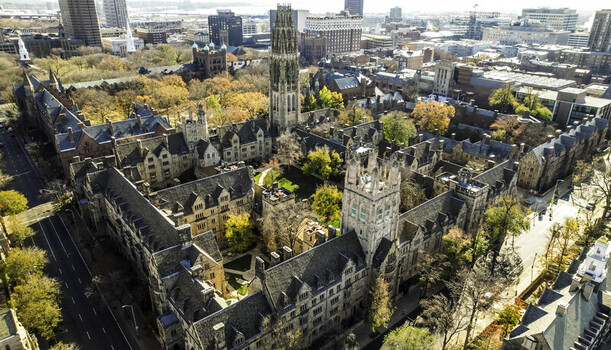 Aerial view of Harkness Tower at Yale University surrounded by historic gothic architecture and autumn foliage in New Haven Connecticut United States.