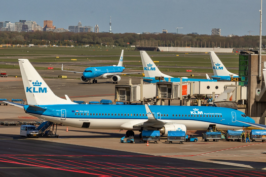 Schiphol Netherlands 16 April 2026 View of KLM Royal Dutch Airlines airplanes parked at the terminal gates with ground handling equipment and the city skyline in the background. Schiphol Netherlands 16 April 2026 View of KLM Royal Dutch Airlines airplanes parked at the terminal gates with ground handling equipment and the city skyline in the background.