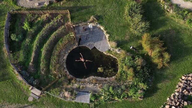 Aerial view of a person floating in a natural pool at a slow camp France.