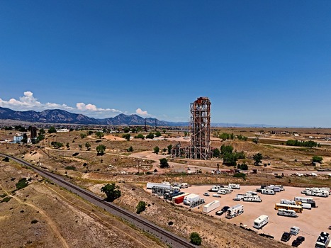 Aerial view of the historic Leyden coal mine tower surrounded by dry rolling hills a railway line and a parking lot in Jefferson County Colorado United States. Aerial view of the historic Leyden coal mine tower surrounded by dry rolling hills a railway line and a parking lot in Jefferson County Colorado United States.