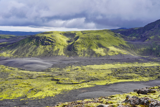 View of the moss covered volcanic hills and black lava fields of the Laki crater area in Kirkjubaejarklaustur Skaftarhreppur Iceland. View of the moss covered volcanic hills and black lava fields of the Laki crater area in Kirkjubaejarklaustur Skaftarhreppur Iceland.