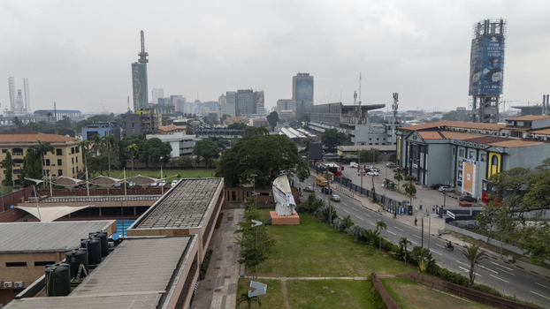 Aerial view of Lagos Island featuring urban architecture high rise buildings a central green space with a statue and a busy road in Lagos Lagos Nigeria. Aerial view of Lagos Island featuring urban architecture high rise buildings a central green space with a statue and a busy road in Lagos Lagos Nigeria.