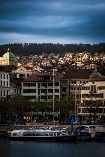 Zurich Switzerland 02 April 2023 View of the city s architecture with the iconic Fraumünster church dome rising above the rooftops reflecting the soft light of dusk. Zurich Switzerland 02 April 2023 View of the city s architecture with the iconic Fraumünster church dome rising above the rooftops reflecting the soft light of dusk.