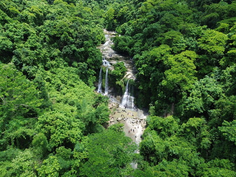 Aerial view of Sitakund waterfall surrounded by dense tropical forest with people swimming in the pool below Sitakund Chittagong Division Bangladesh. Aerial view of Sitakund waterfall surrounded by dense tropical forest with people swimming in the pool below Sitakund Chittagong Division Bangladesh.