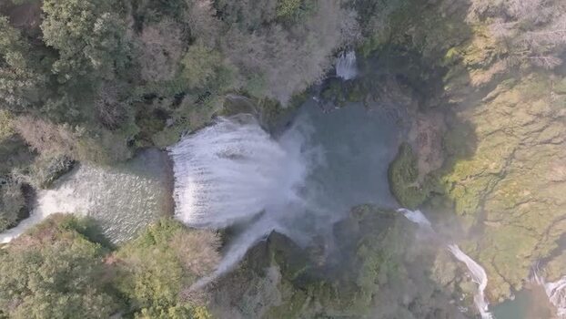Aerial view of Marmore Falls cascading over rocky cliffs Italy.