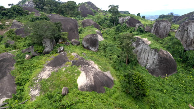 Aerial view of Idanre Hill featuring massive granite boulders surrounded by lush tropical vegetation and dense forest in Idanre Ondo State Nigeria. Aerial view of Idanre Hill featuring massive granite boulders surrounded by lush tropical vegetation and dense forest in Idanre Ondo State Nigeria.