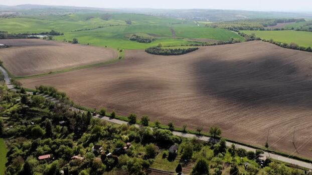 Aerial view of rolling agricultural fields and rural road Czechia.