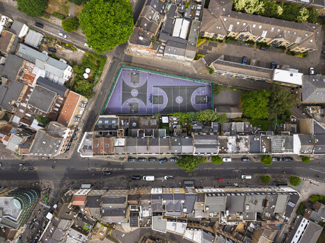 Aerial view of the Shoreditch basketball court surrounded by dense urban architecture terraced housing and narrow streets in London England United Kingdom. Aerial view of the Shoreditch basketball court surrounded by dense urban architecture terraced housing and narrow streets in London England United Kingdom.