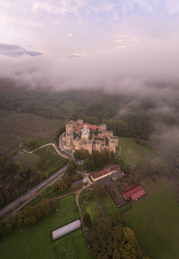 Aerial view of Manasija Monastery surrounded by low clouds and lush green landscape in Despotovac Pomoravski okrug Serbia.