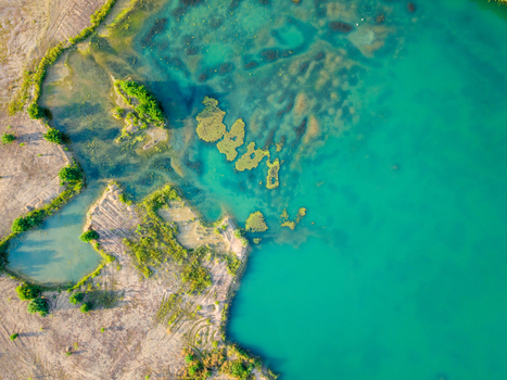 Aerial view of Piskovna Dobrin sand pit with turquoise water sandy banks and lush green vegetation in Dobrin Ustecky kraj Czechia. Aerial view of Piskovna Dobrin sand pit with turquoise water sandy banks and lush green vegetation in Dobrin Ustecky kraj Czechia.