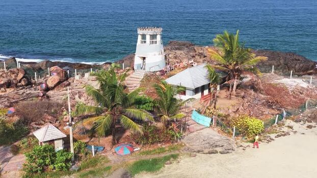 Aerial view of a coastal tower and palm trees in Kovalam India. Aerial view of a coastal tower and palm trees in Kovalam India.