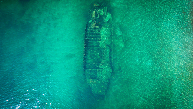 Aerial view of the Kontesa shipwreck submerged in crystal clear turquoise waters of the Adriatic Sea in Necujam Split Dalmatia County Croatia. Aerial view of the Kontesa shipwreck submerged in crystal clear turquoise waters of the Adriatic Sea in Necujam Split Dalmatia County Croatia.