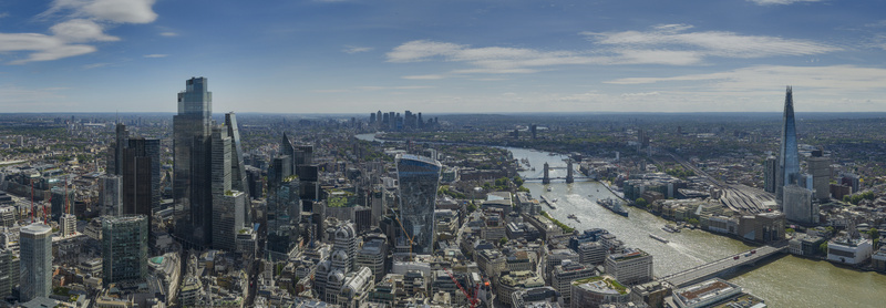 Aerial view of The Fenchurch Building and the City of London skyline along the River Thames with Tower Bridge and The Shard in London England United Kingdom. Aerial view of The Fenchurch Building and the City of London skyline along the River Thames with Tower Bridge and The Shard in London England United Kingdom.