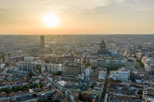 Aerial view of the Palais de Justice and the urban skyline of Brussels at sunset featuring dense rooftops and a Ferris wheel in the city center of Brussels Brussels Belgium. Aerial view of the Palais de Justice and the urban skyline of Brussels at sunset featuring dense rooftops and a Ferris wheel in the city center of Brussels Brussels Belgium.
