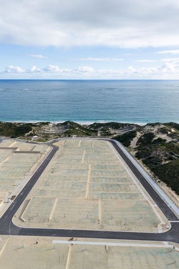 Aerial view of a residential development site with newly paved roads and cleared land plots situated along the coastline in Perth Western Australia Australia. Aerial view of a residential development site with newly paved roads and cleared land plots situated along the coastline in Perth Western Australia Australia.