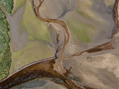 Aerial view of Findhorn Bay with meandering water channels sandy banks and green marshland in Findhorn Scotland United Kingdom. Aerial view of Findhorn Bay with meandering water channels sandy banks and green marshland in Findhorn Scotland United Kingdom.
